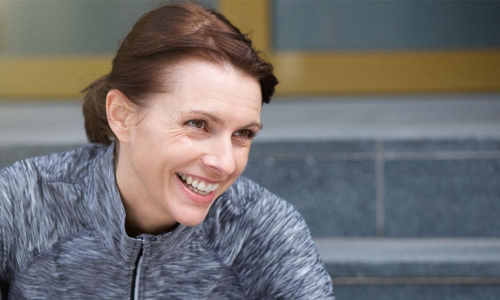 middle aged woman in sports jacket smiling