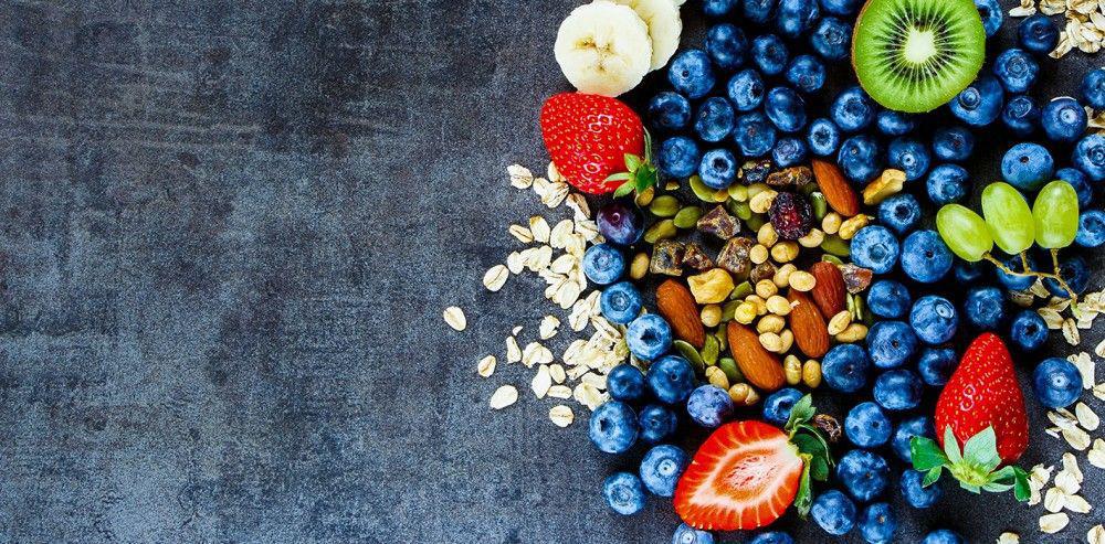 aerial view of colorful fruit and seeds on gray table